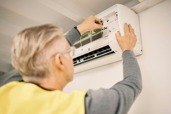 maintenance-installation-and-back-of-a-man-with-air-conditioner-for-service-and-ac-repair-buildin
